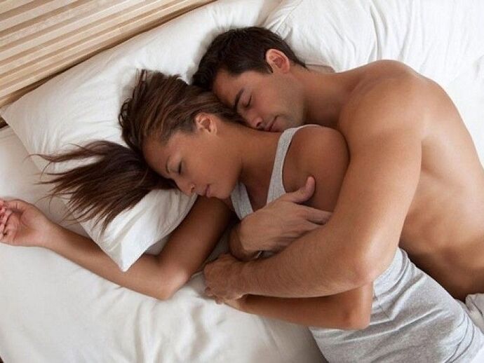 a woman in bed with a man who has enhanced potency